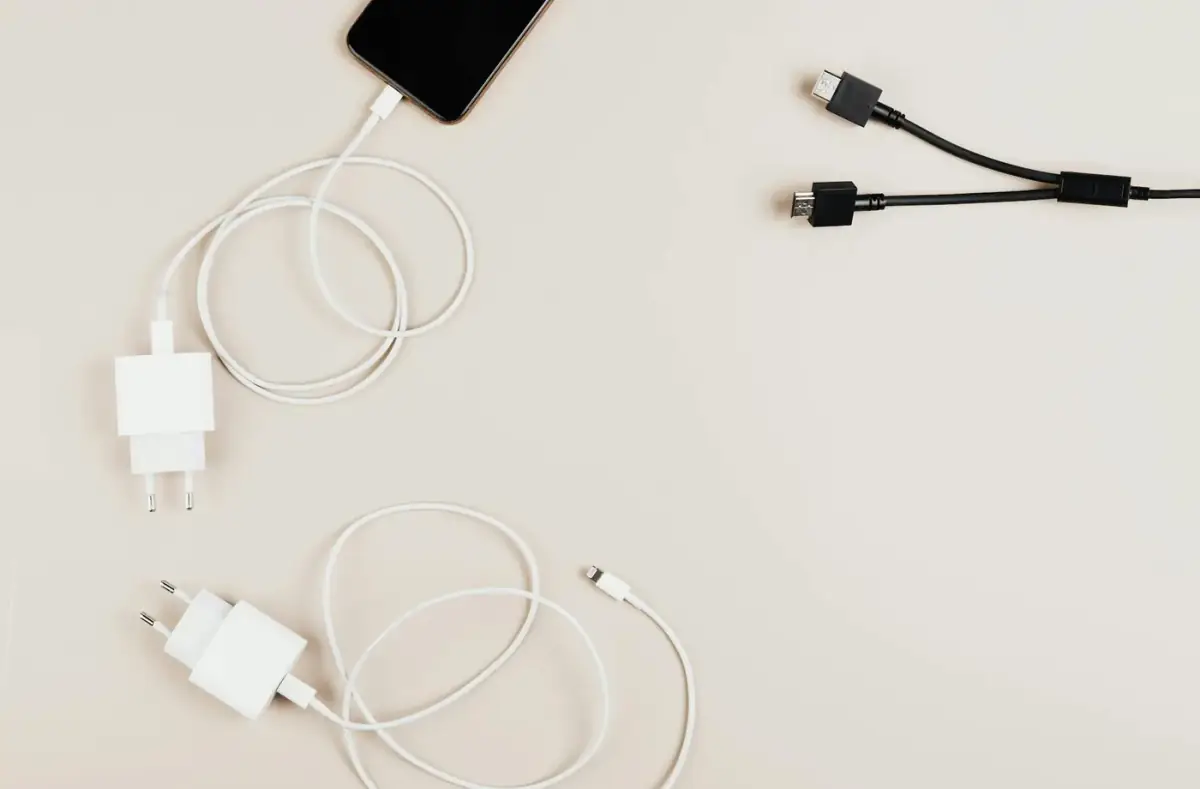 Charging cables and adapters arranged on a desk