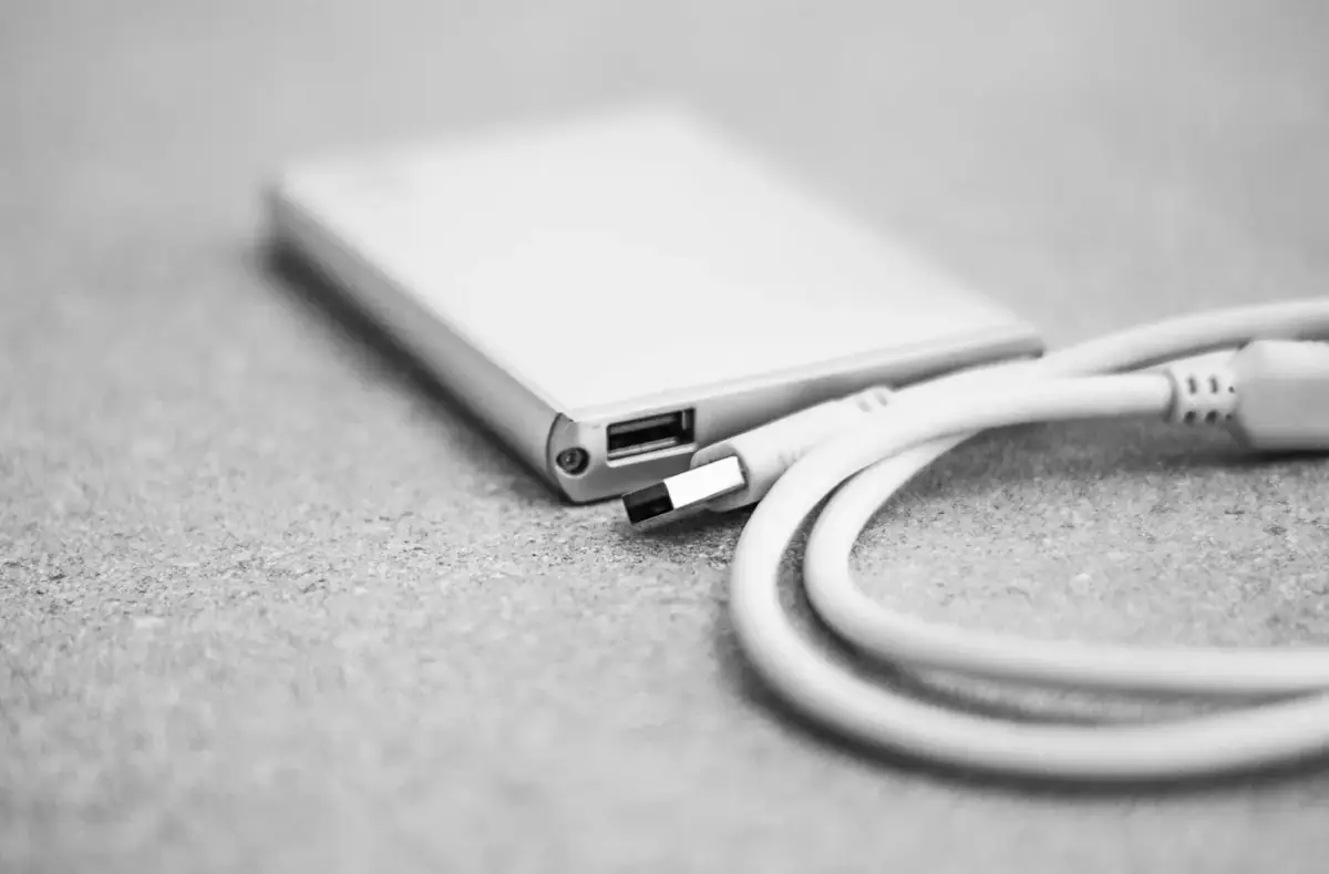Close-up of a storage drive connected by USB cable